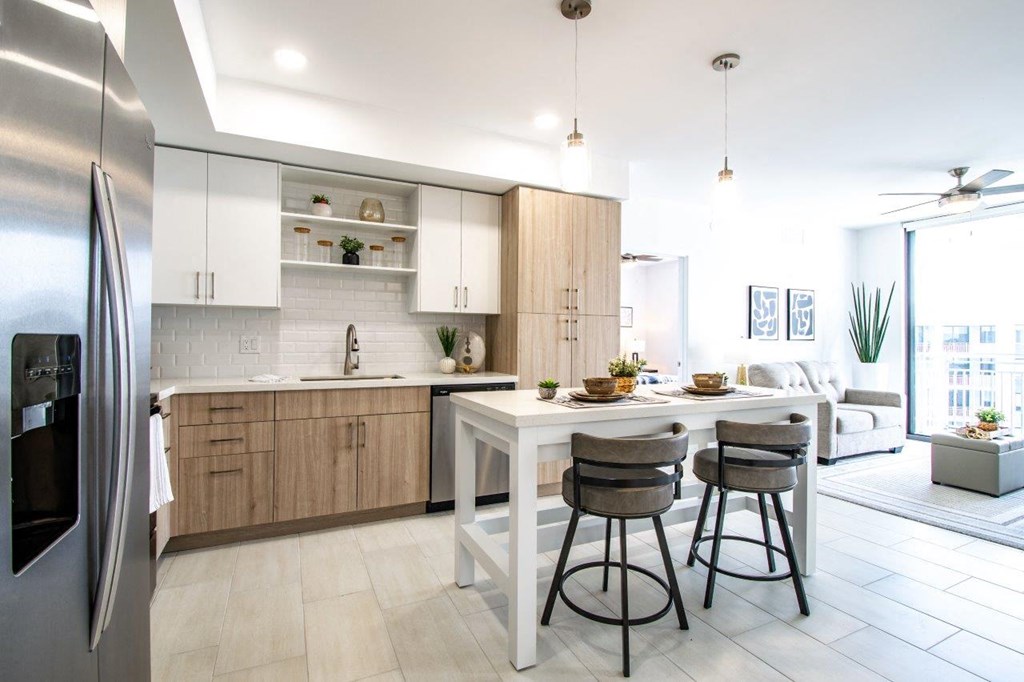 a kitchen and living room with a table and chairs