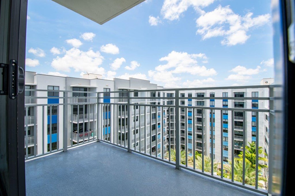a balcony with a view of a building and a blue sky