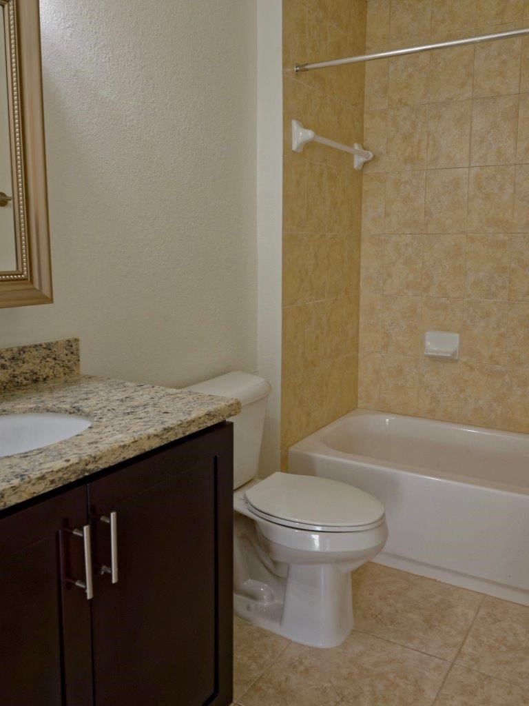 a bathroom with a toilet and a sink and a bath tub