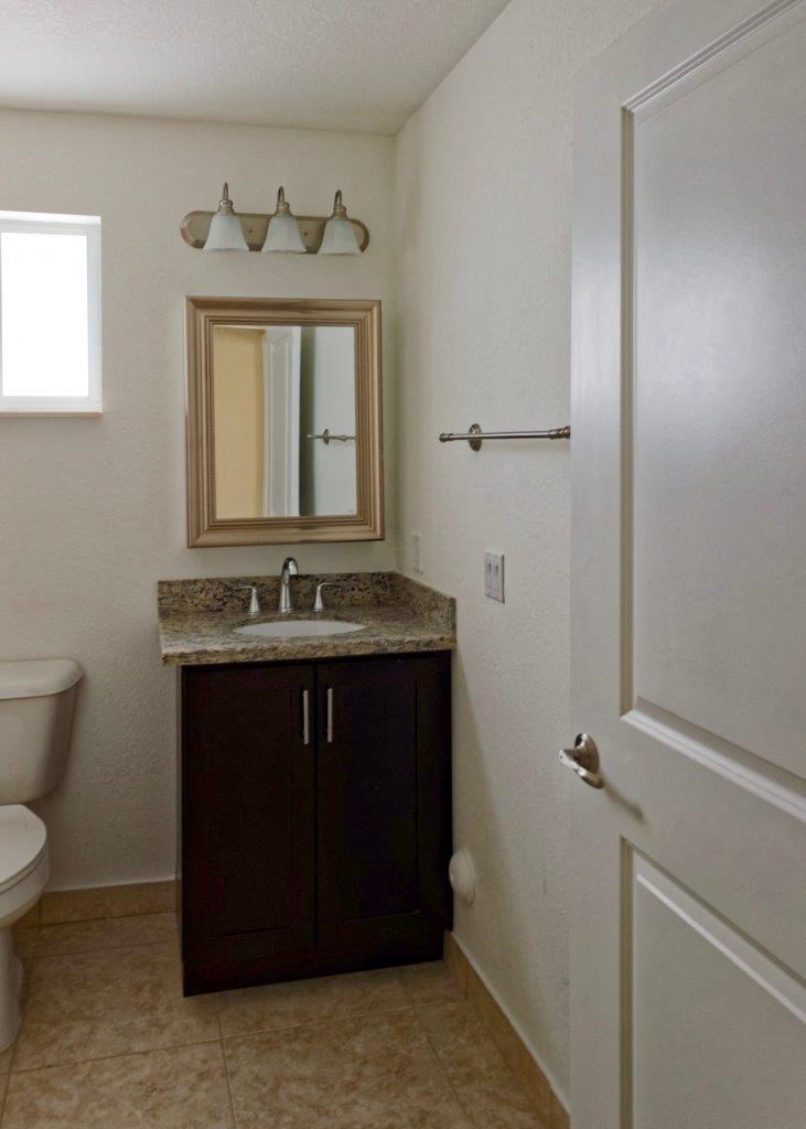 a bathroom with a sink and a toilet and a mirror