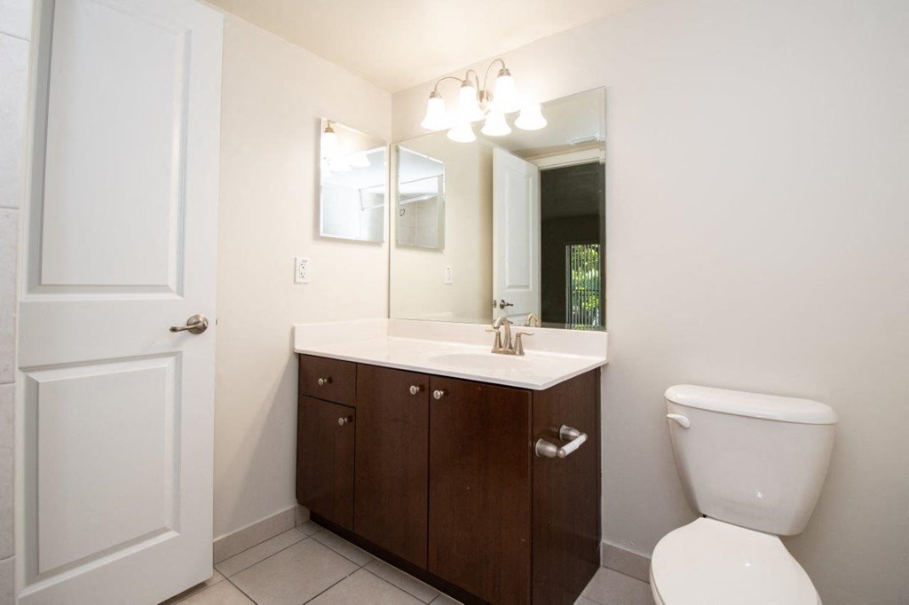 a bathroom with a toilet sink and a mirror