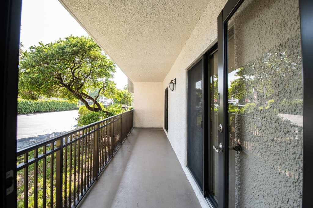 a balcony with a view of a river and trees