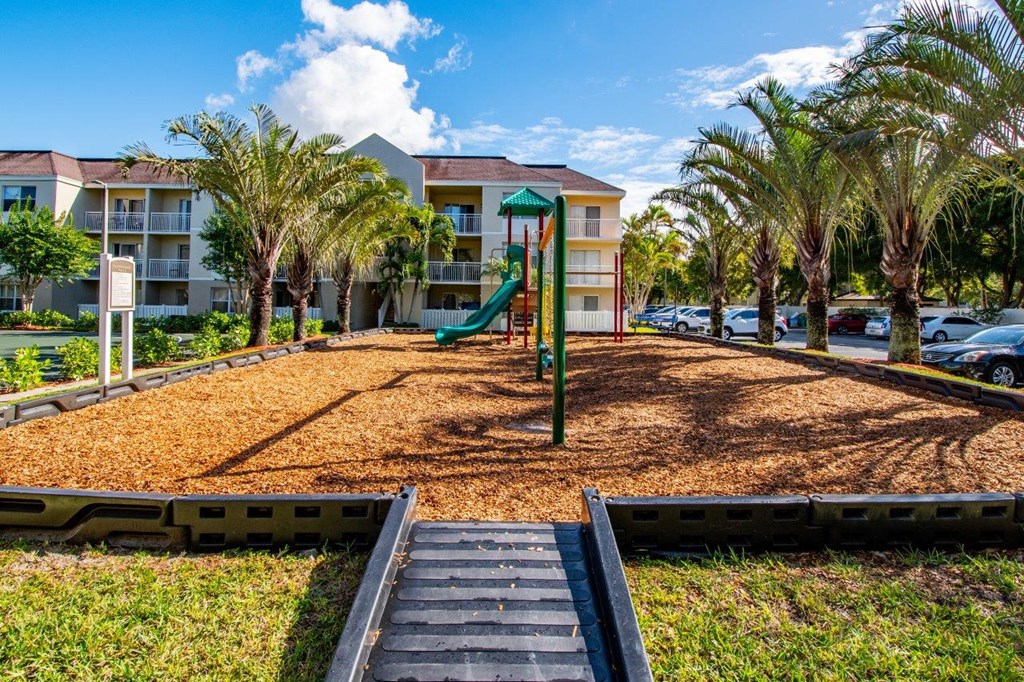 a playground with a slide in front of a building