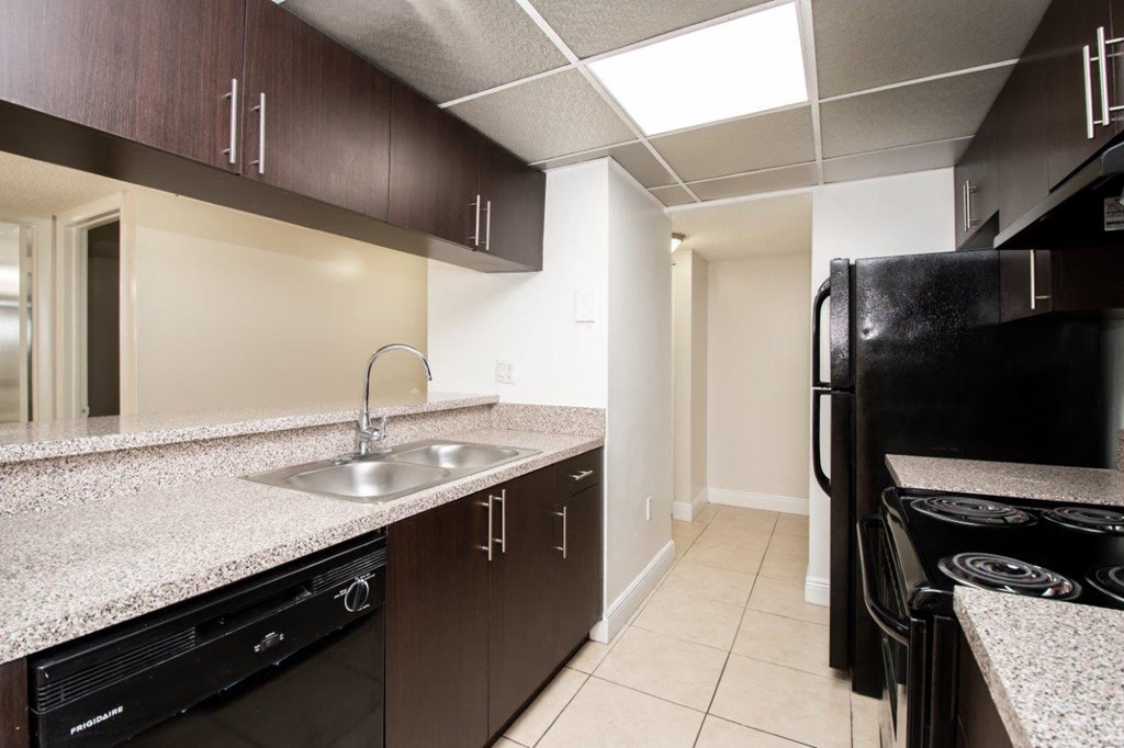 a kitchen with a sink and a refrigerator