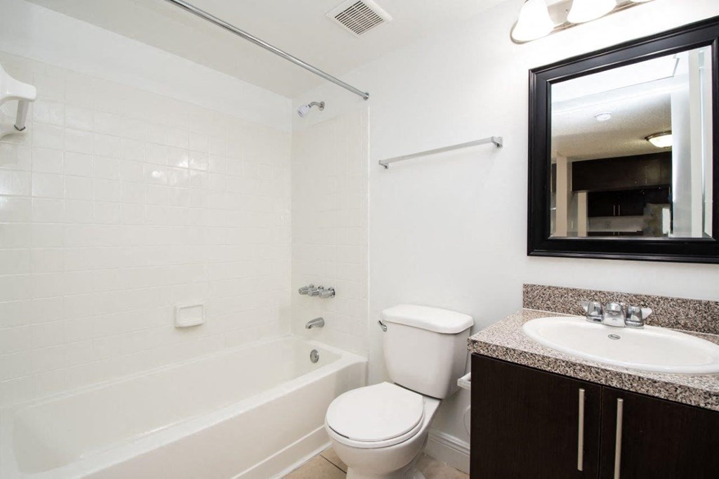 a bathroom with a sink toilet and a bath tub