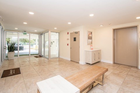 a hall with a wooden bench and a table