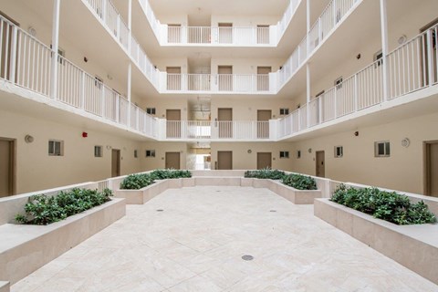 arium of a hotel with balconies and plants