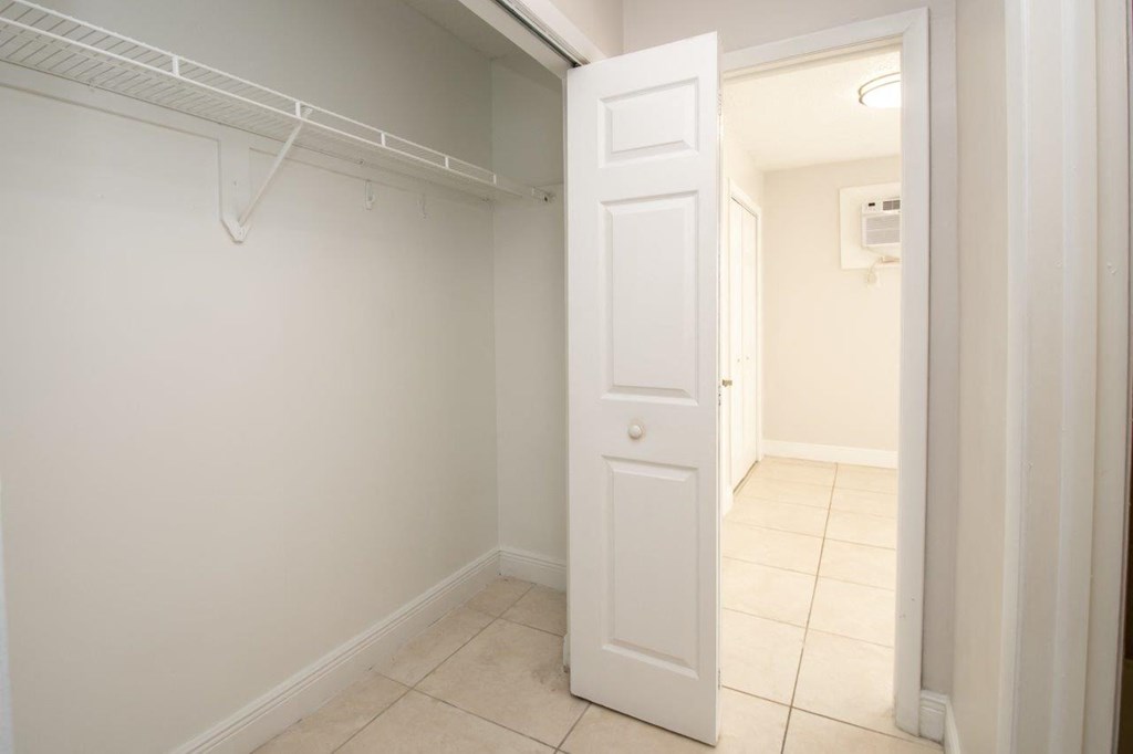a room with a closet and a white door