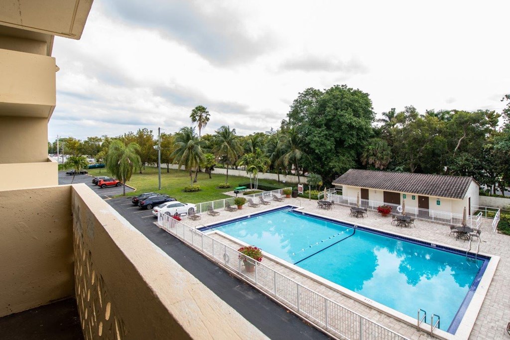 a view of the pool from the balcony of a house