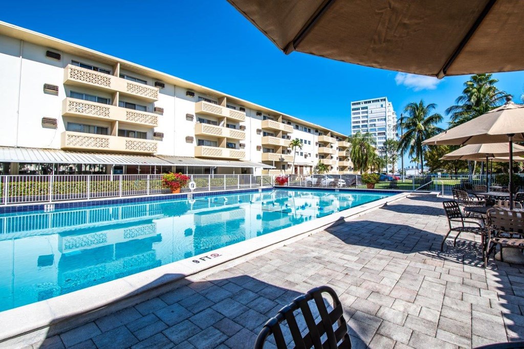 a large swimming pool in front of a hotel
