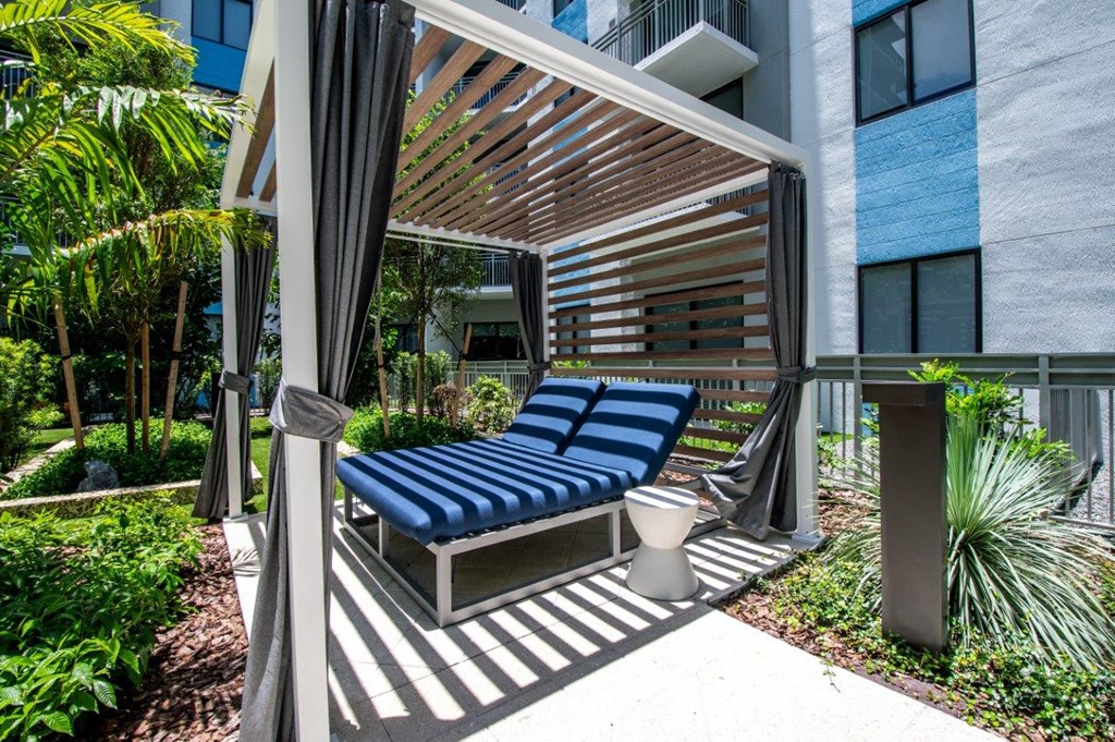 a lounge area with a couch and a toilet in a courtyard
