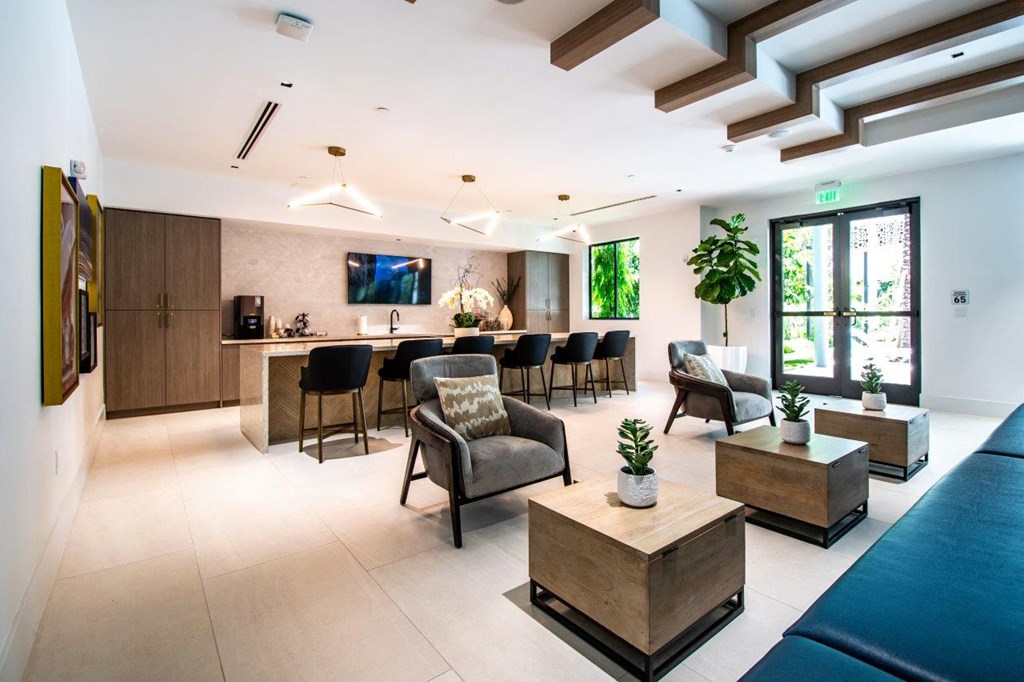 the lobby or reception area of a hotel with a bar and a living room