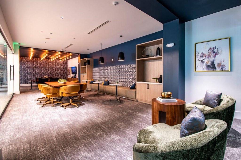 a living room and dining room with a table and chairs