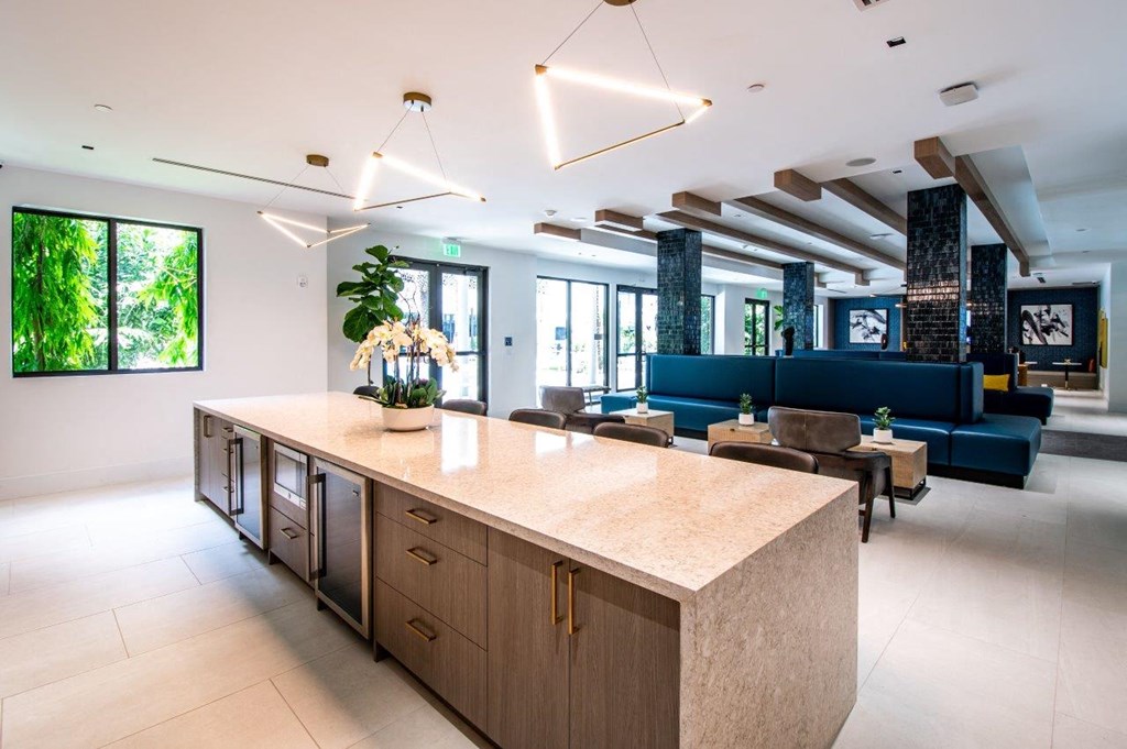 the lobby or reception area of a hotel with a large kitchen and living room