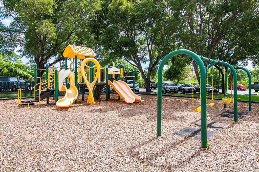 a playground with slides and monkey bars in a park