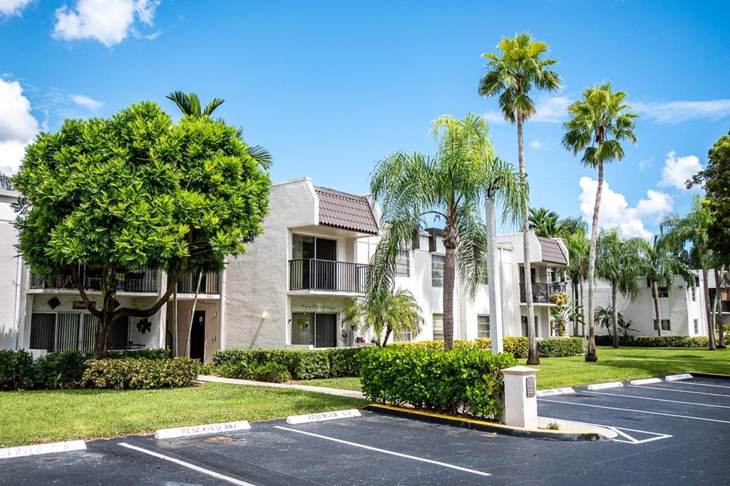 a large white building with palm trees in front of it