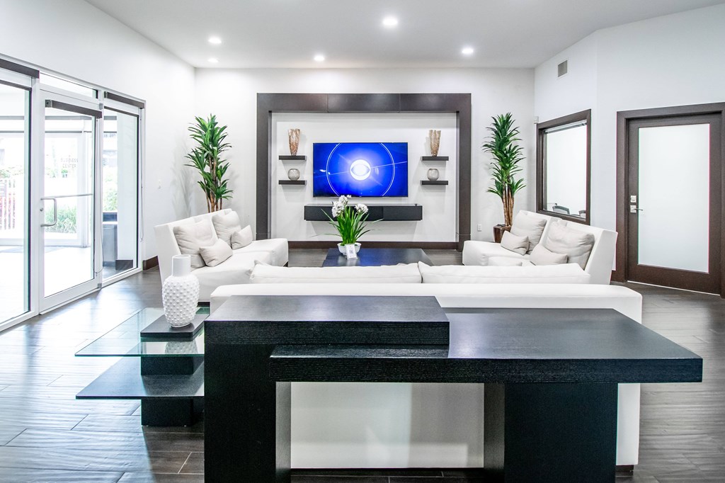 A modern living room with a white sofa and a black coffee table.