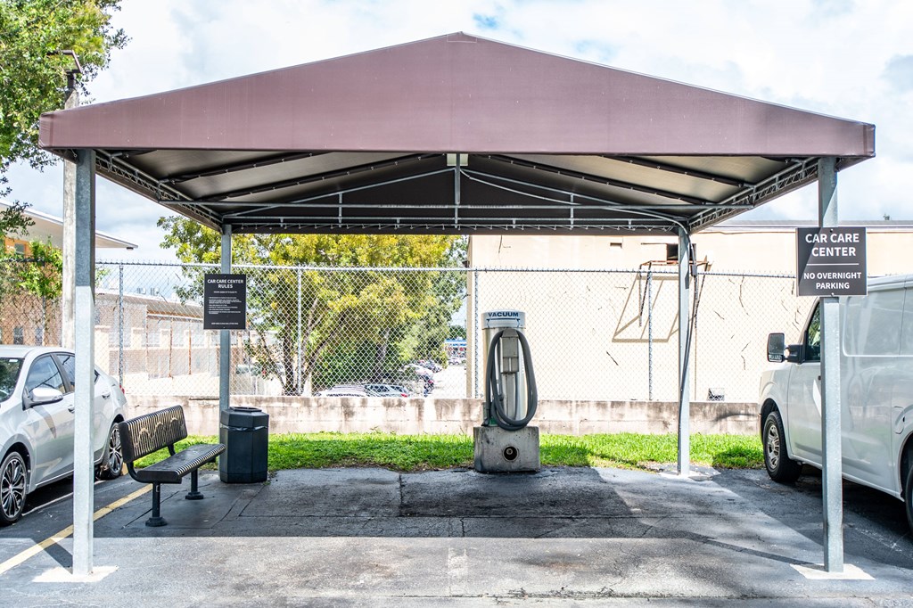 A car care center with a canopy and a sign that reads "NO OVERNIGHTS".
