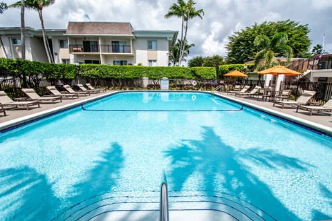 A swimming pool with a building in the background.
