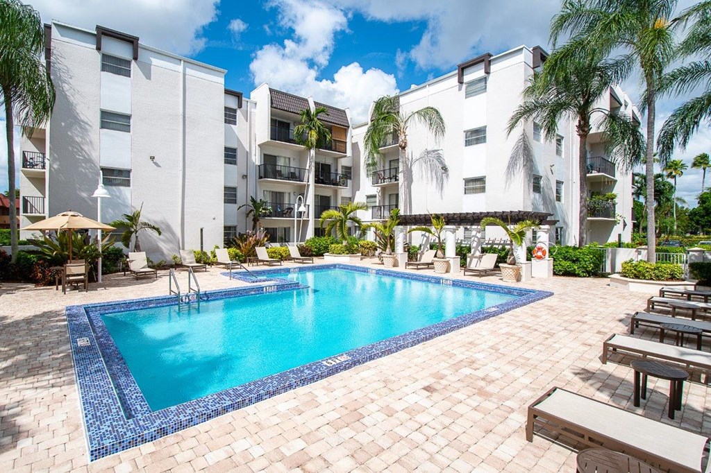 a large swimming pool in front of an apartment building