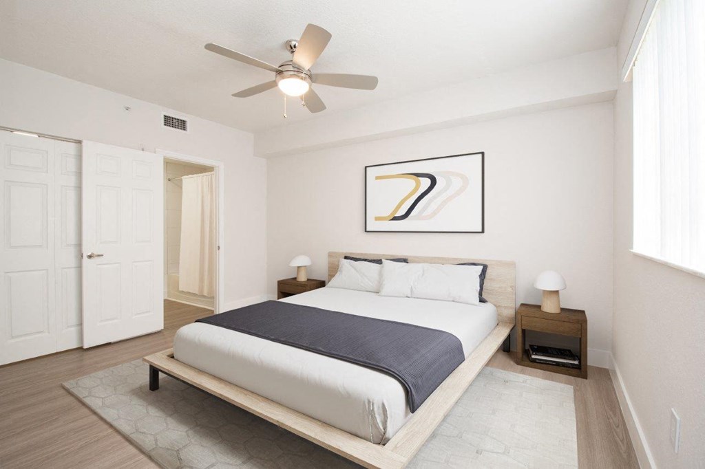 a bedroom with a bed and a ceiling fan