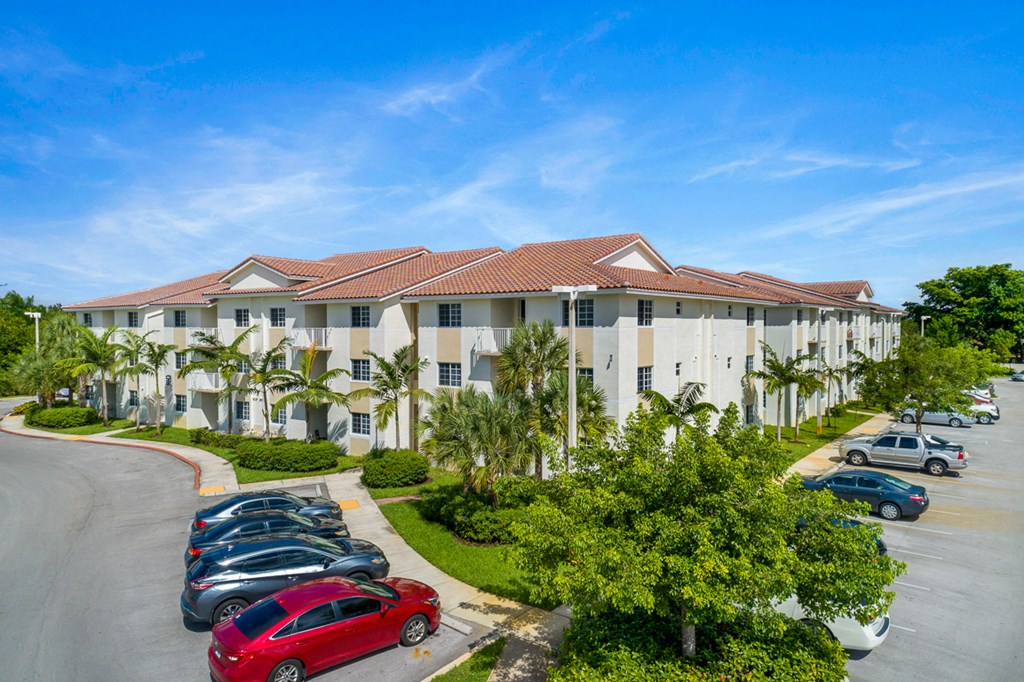 a large building with cars parked in a parking lot