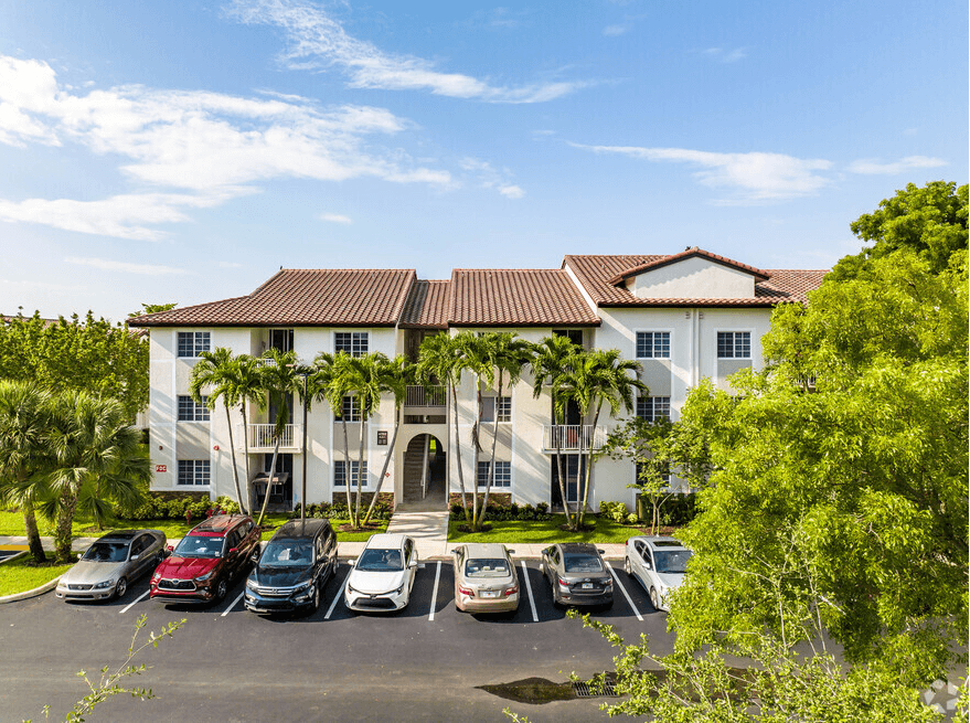 a large white building with cars parked in front of it
