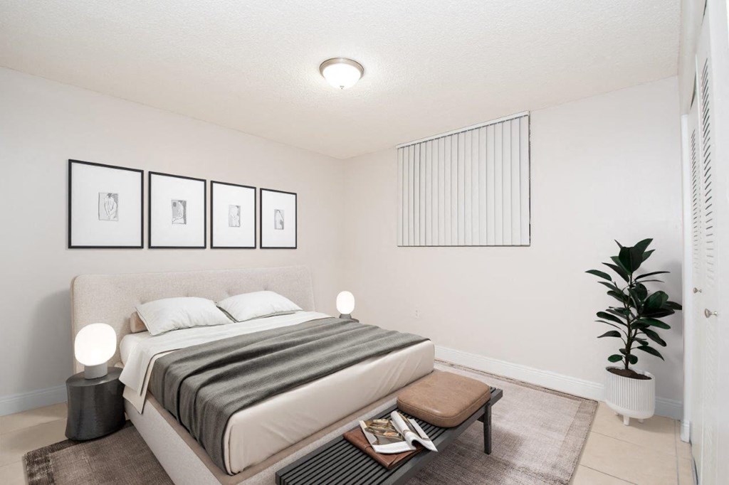 an image of a bedroom with a bed and a plant