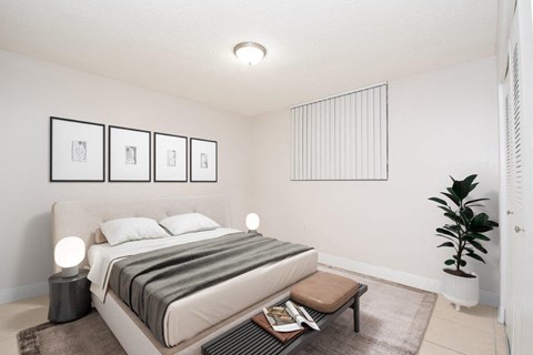 an image of a bedroom with a bed and a plant