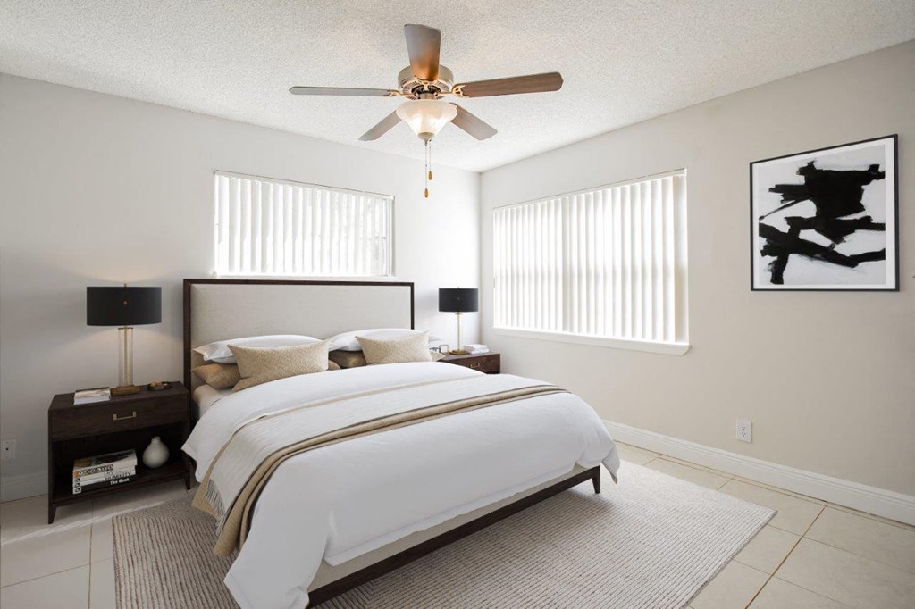 a bedroom with a bed and a ceiling fan