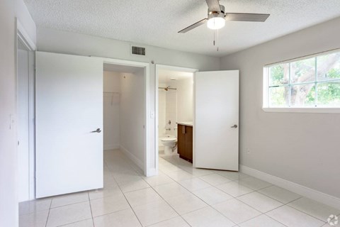 A white room with a ceiling fan and a window.