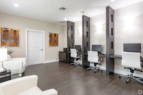 A conference room with white chairs and a white door.