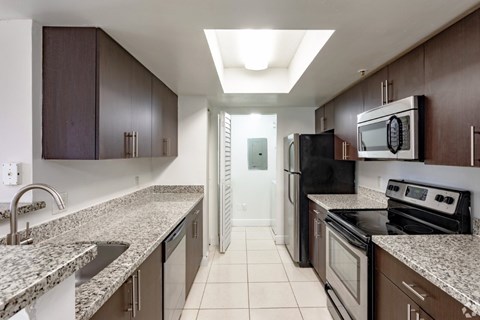 A kitchen with granite countertops and stainless steel appliances.