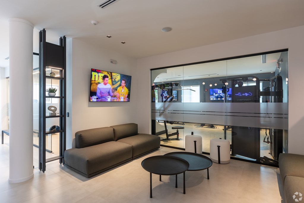 A modern living room with a grey sofa and a television.