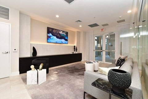 a large living room with a couch and a tv