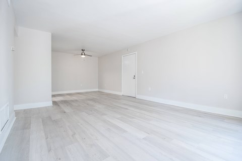 A room with a ceiling fan and light fixture.