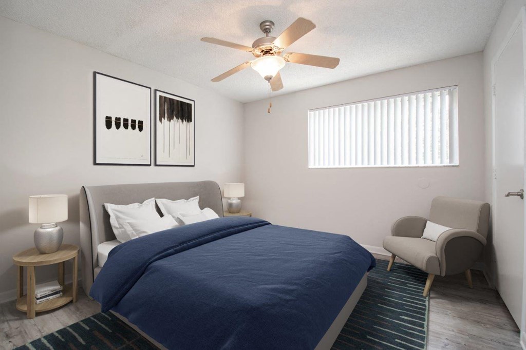 a bedroom with a bed and a ceiling fan