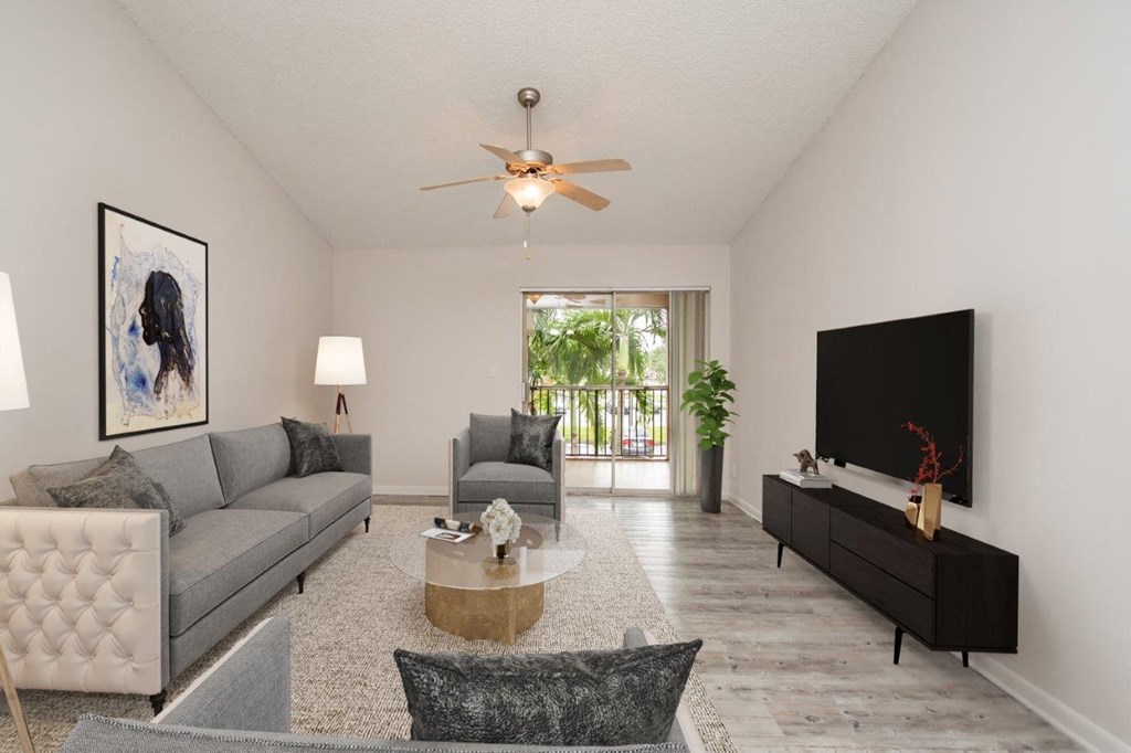 a living room with a couch and a ceiling fan