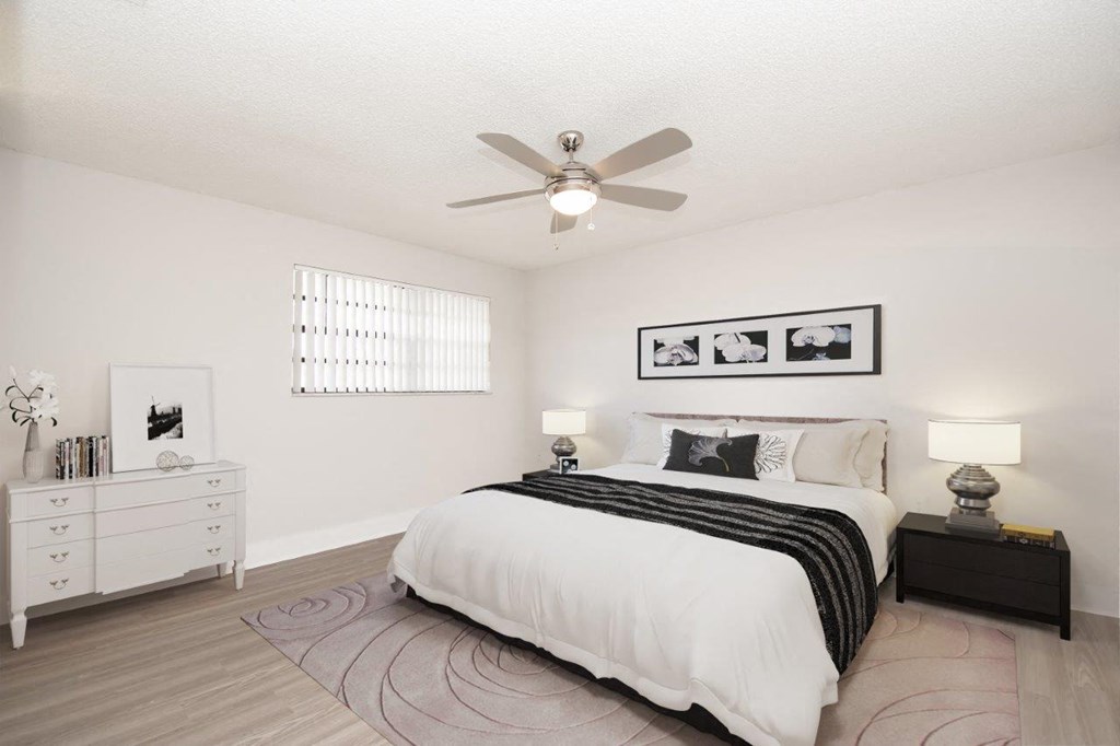 a bedroom with a bed and a ceiling fan