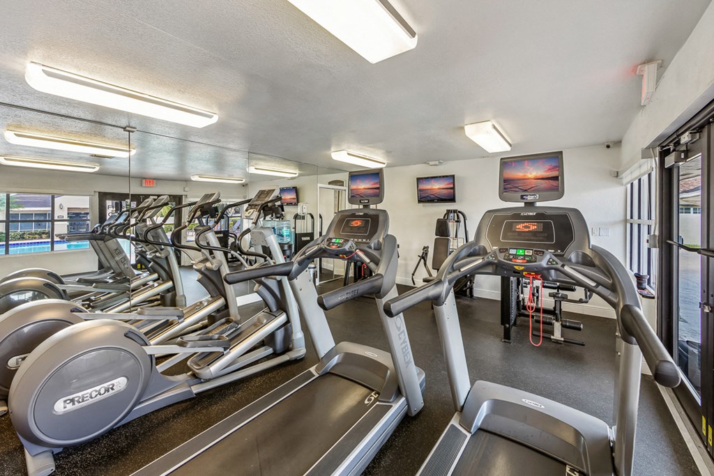the gym has cardio equipment and machines at the enclave at university heights apartments
