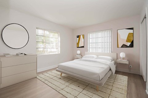 a white bedroom with a bed and a mirror