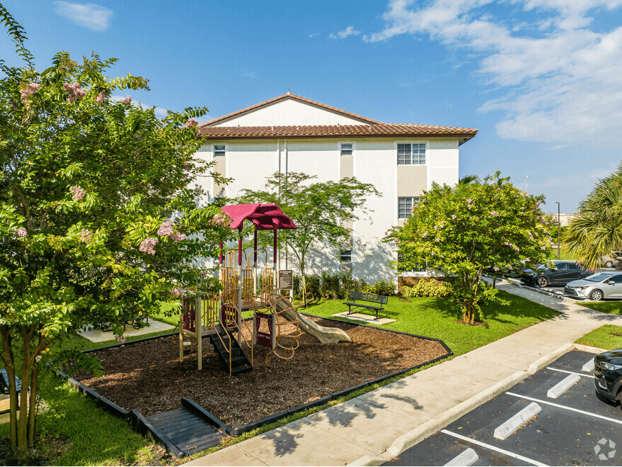 a playground in a garden in front of a building