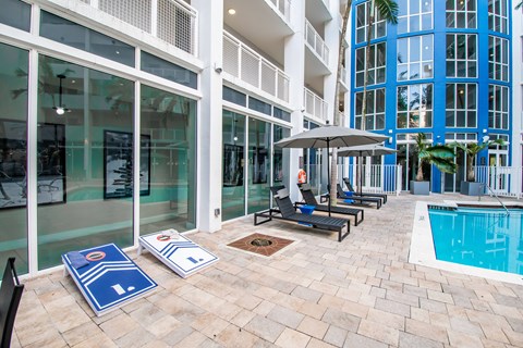 A pool area with a blue mat and a pool table.