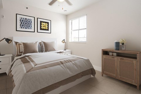 a white bedroom with a bed and a window