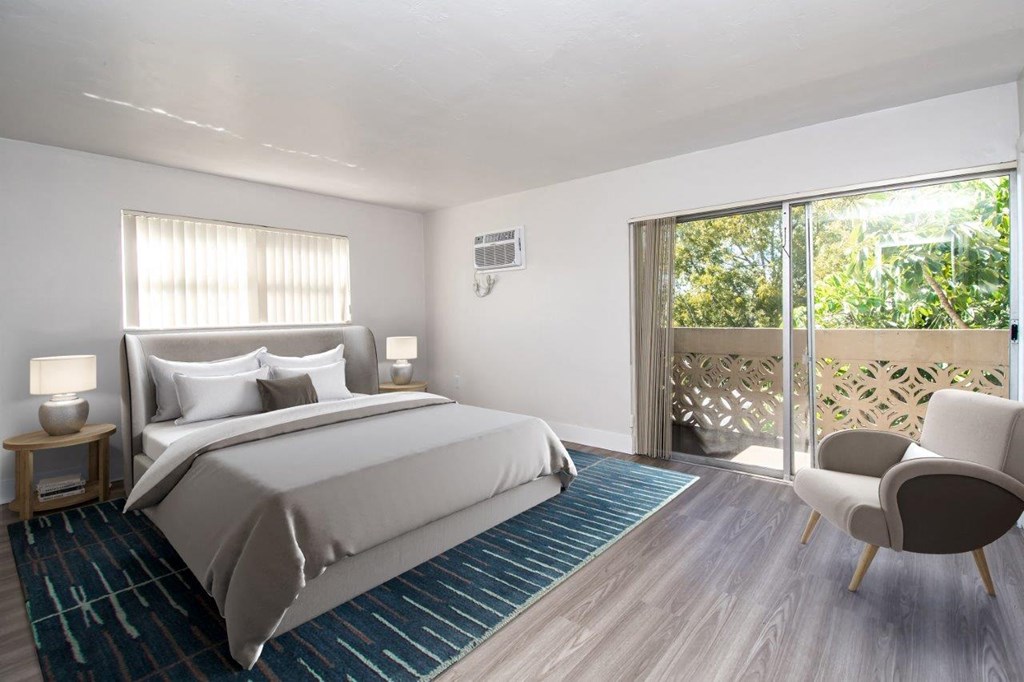 a bedroom with a bed and a door to a balcony