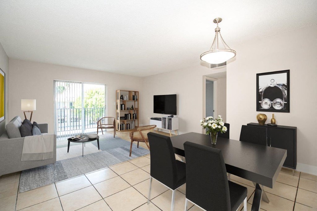a dining room and living room with a table and chairs