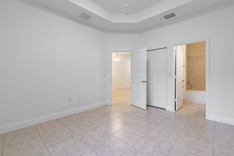 A large empty room with a door on the right side.