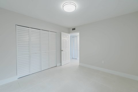 A room with white walls and a white door.