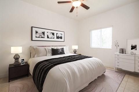 a bedroom with a bed and a ceiling fan