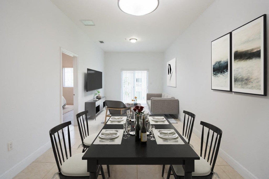 a dining room with a black table and chairs